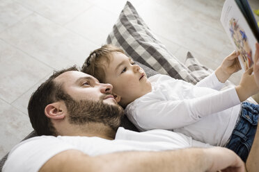 Father and son reading a book together - OJF00195