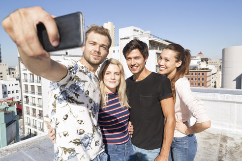 Friends taking selfies on a rooftop terrace - WESTF23073