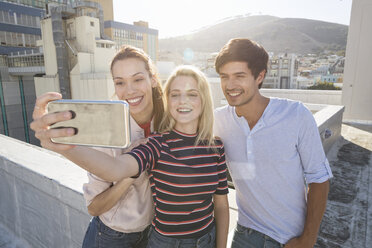 Friends taking selfies on a rooftop terrace - WESTF23099