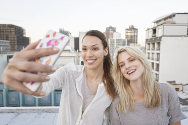Friends taking selfies on a rooftop terrace - WESTF23144