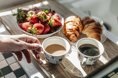 Strawberries, croissants and coffee in kitchen stock photo