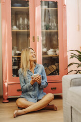 Happy woman at home sitting on the floor - JOSF00847