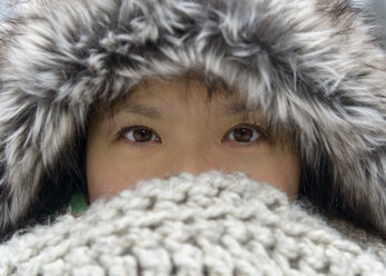 Portrait of woman wearing fur cap covering nose and mouth with scarf - TOVF00077