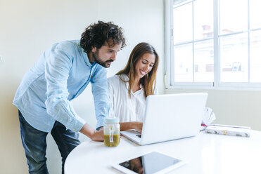 Couple working with laptop at home - KIJF01497