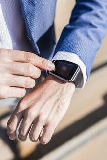 Close-up of businessman with smartwatch - GIOF02590