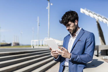 Young businessman using tablet outdoors - GIOF02605