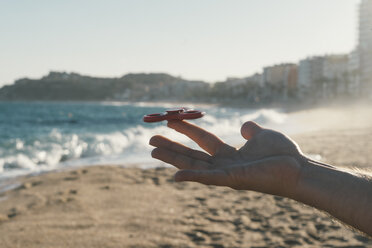 Man balancing Fidget spinner on his finger - SKCF00293