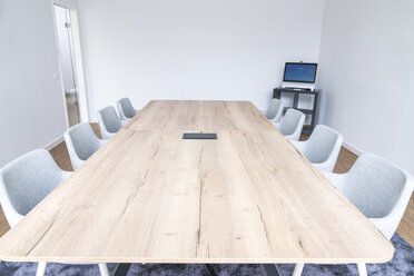 Empty board room with wooden conference table - FMKF04131