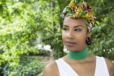 Portrait of young woman with piercings wearing traditional Brazilian headgear - ABZF02019