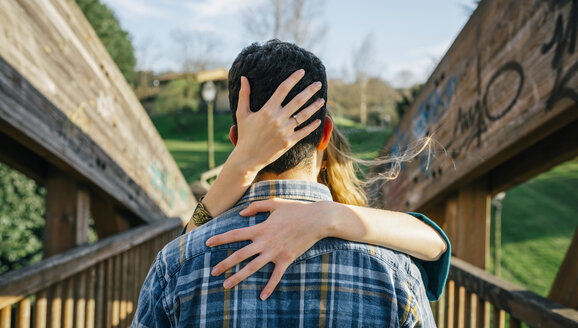 Back view of young man kissed by his girlfriend - DAPF00751