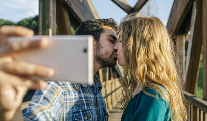 Verliebtes Paar macht Selfie mit Smartphone beim Küssen - DAPF00753