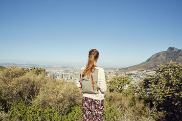 South Africa, Cape Town, Signal Hill, young woman overlooking the city - SRYF00515