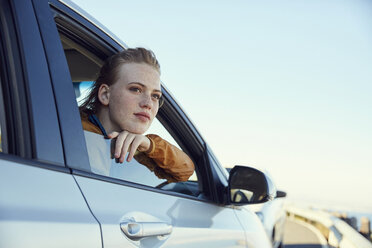 Junge Frau schaut aus einem Auto heraus - SRYF00547