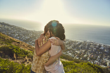 South Africa, Cape Town, Signal Hill, two young women hugging above the city - SRYF00567