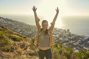 South Africa, Cape Town, Signal Hill, portrait of happy young woman above the city - SRYF00572