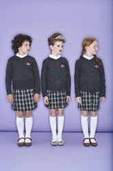 Three girls wearing school uniform standing side by side - FSF00881