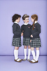 Three girls wearing school uniform talking - FSF00884