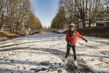 Woman ice skating on canal - MFF03509