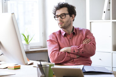 Man sitting at desk in office - FKF02302