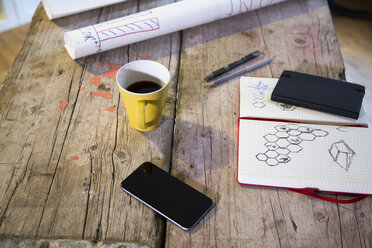 Notebook, smartphone and coffee cup in modern informal office - FKF02324