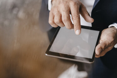 Close-up of businessman using tablet - KNSF01262