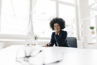 young businesswoman sitting in her office - KNSF01393