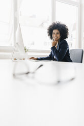 young businesswoman sitting in her office - KNSF01394