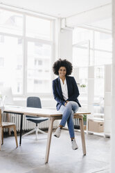 young businesswoman sitting in her office - KNSF01395