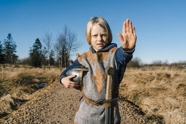 Portrait of little boy wearing knight costume in nature - KNSF01445