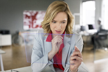 Businesswoman using futuristic portable device - PESF00589