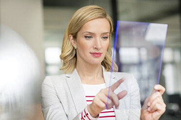 Businesswoman using futuristic portable device - PESF00616