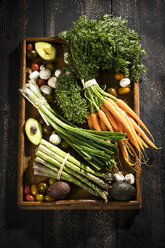 Various organic vegetables on dark wooden tray - MAEF12210