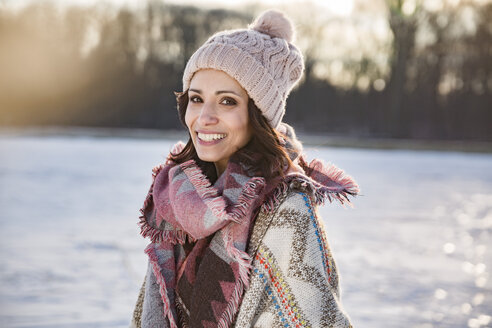 Portrait of happy woman outdoors in winter - MFF03557