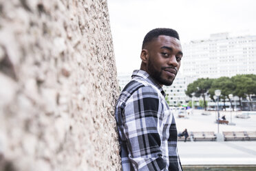 Spain, Madrid, portrait of young man leaning against wall - ABZF02035