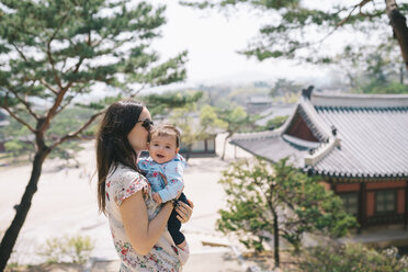 South Korea, Seoul, Mother and baby girl visiting Changdeokgung Palace and Huwon - GEMF01636