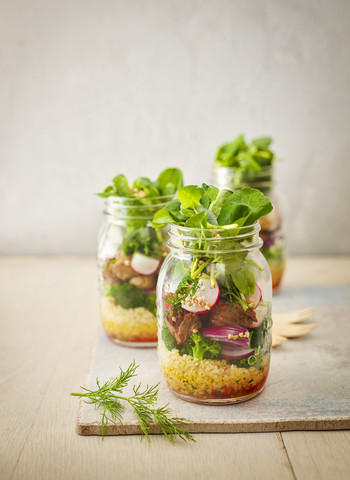 Preserving jar of buckwheat salad with vegetables and diced Striploin Steak stock photo