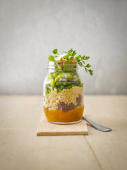 Preserving jar of quinoa salad with vegetables, coconut chips and meat balls - KSWF01816