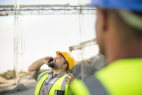 Quarry worker on site talking on the phone stock photo