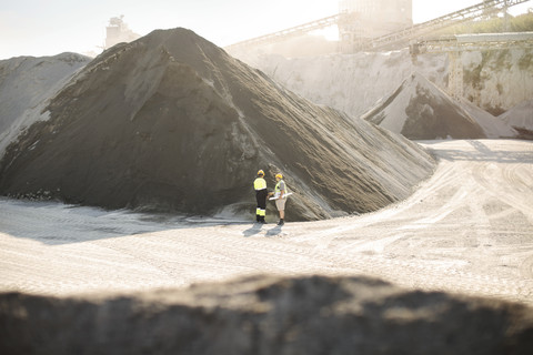 Workers standing at quarry stock photo