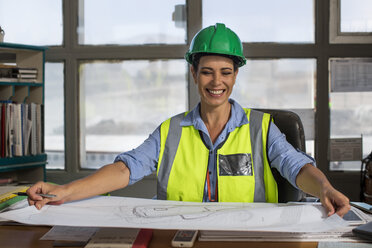 Female worker sitting in site office of quarry - ZEF13750