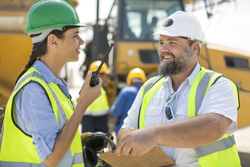 Male and female quarry workers discussing on site - ZEF13762