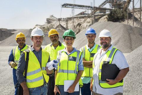 Team of quarry workers looking at camera, looking confindent stock photo