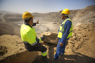 Two quarry workers looking over quarry - ZEF13772