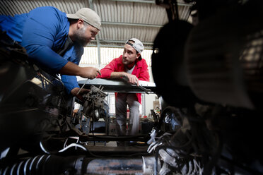 Mechanics repairing car in workshop - ZEF13801