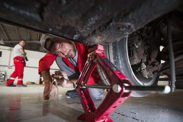 Mechanics repairing car in workshop - ZEF13803