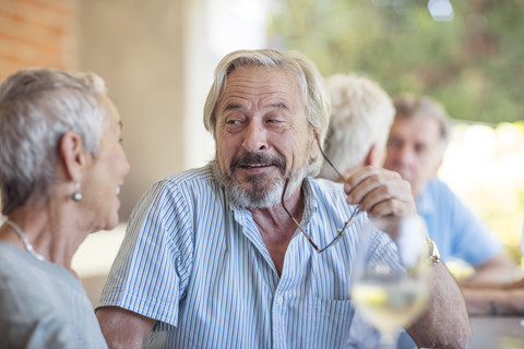 Portrait of senior man listening senior woman stock photo