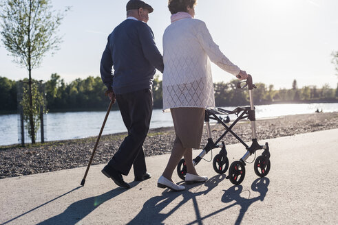 Glückliches älteres Paar spaziert in der Nähe des Flusses - UUF10661