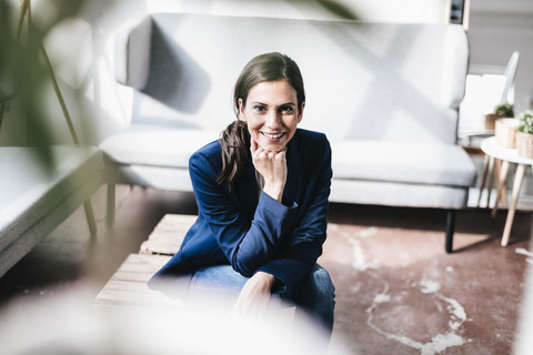 Portrait of confident businesswoman sitting down stock photo