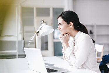 Businesswoman with laptop at table thinking - JOSF00974