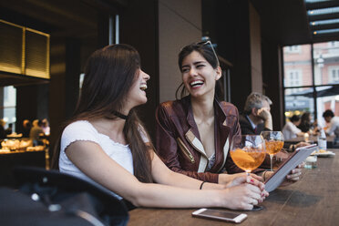 Zwei glückliche junge Frauen in einer Bar - MRAF00207